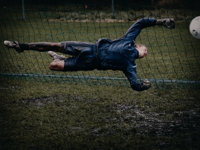 Goalkeeper diving full stretch to make a save